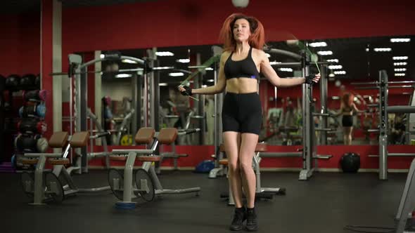 Young woman jumping rope in the gym, slow motion