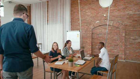 Follow Shot of Employee on Hoverboard Scooter Coming To Startup Loft Office Work