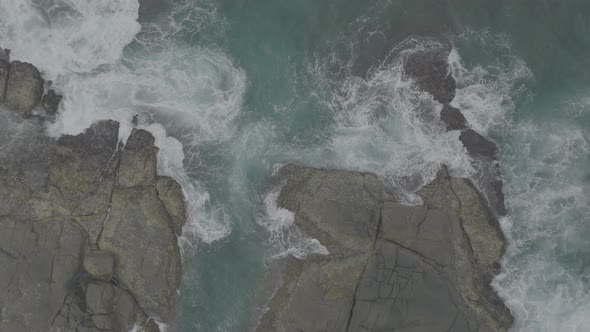 Waves Crash Against Rocks in the Ocean