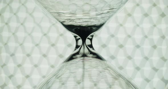 Transparent hourglass and bokeh lights.