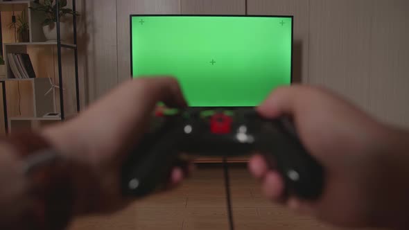 Hands Gamer Using Joystick Play A Game With Green Screen Tv At Home