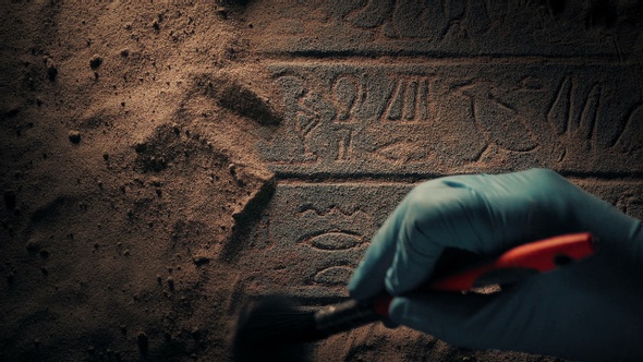 Brushing Off Sand From Egyptian Writing