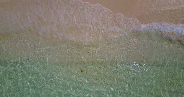 Wide angle fly over abstract view of a white sandy paradise beach and aqua blue water background in 