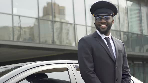 Personal Driver Giving Passers-By Sincere Smile Waiting for Boss from Airport