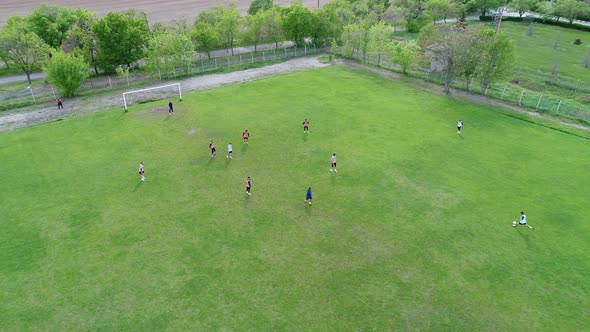 Group of Young Boys Play Soccer, Training Day on the Football Field