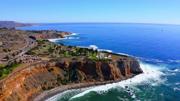 Slow aerial drone view flying towards the light house on the cliffs of Rancho Palos Verdes in Southe