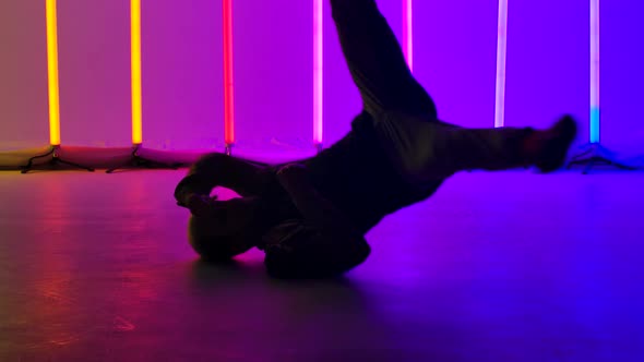 Experienced Dancer Performs Complex Break Dance Elements, Spins on the Floor and Does a Headstand