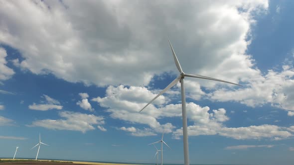 Industrial Wind Energy Turbines the Blue Sky in Thick White Clouds, Aerial Survey