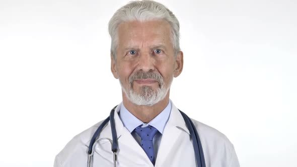 Portrait of Senior Doctor Shaking Head to Allow White Background