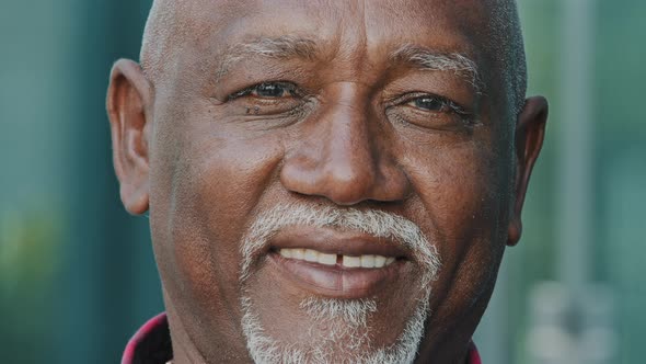 Portrait of Happy Old 80s African American Man Looking at Camera Smiling Posing Outdoors