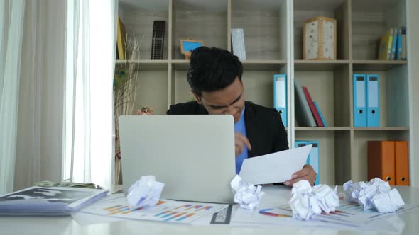 Stressed businessman hand holding crumpled business paper and anger