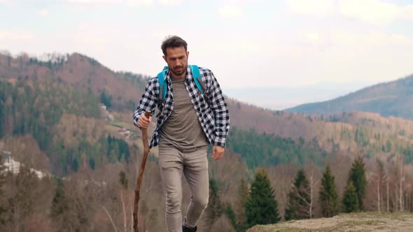 Tired hiking man taking a short break