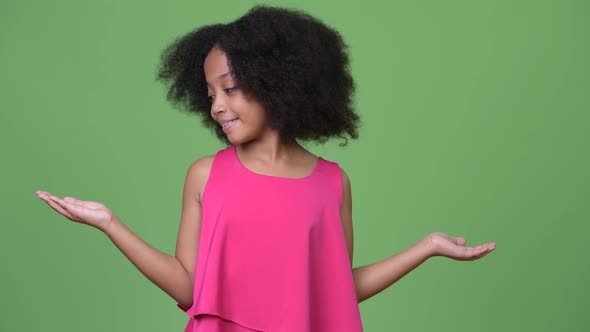 Young Cute African Girl with Afro Hair Choosing Between Left and Right