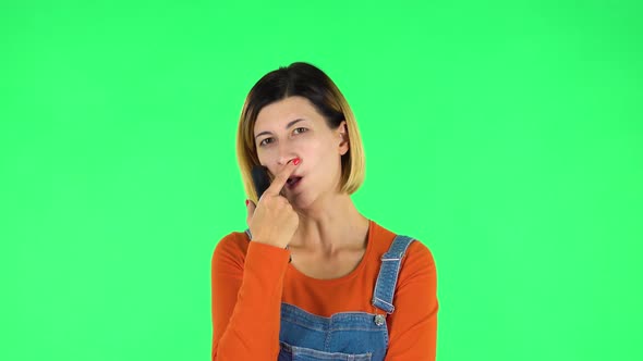 Woman with TV Remote in Her Hand, Switching on TV. Green Screen