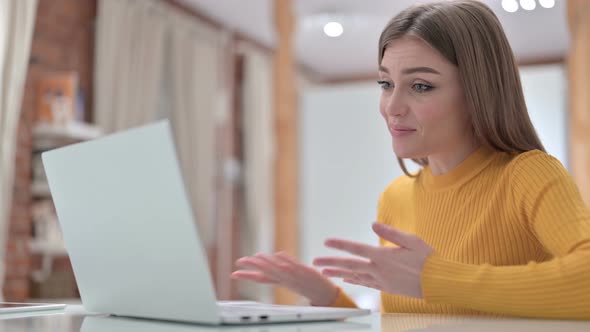 Beautiful Young Woman Doing Video Chat on Laptop