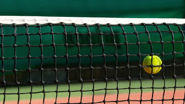 Super Slow Motion Shot of Tennis Ball Hitting the Net on Court at 1000Fps