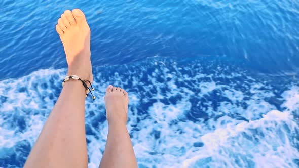 Woman Legs with Blue Sea Water on Background