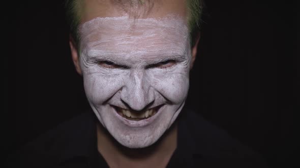 Clown Halloween Man Portrait. Close-up of an Evil Clowns Face. White Face Makeup