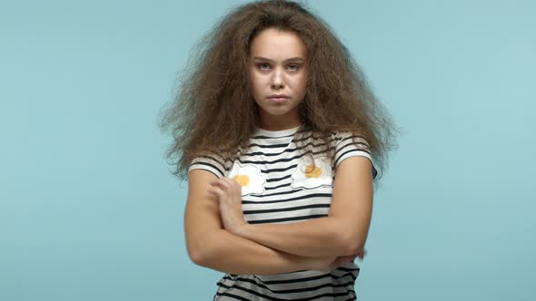 Slow Motion of Young Pretty Girl with Wavy Messy Hair Looking Angry and Offended Standing with Hands
