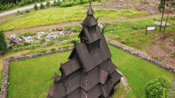 Beautiful wooden Heddal Stave Church in Notodden, Norway. Aerial shot, pull back revealing landscape