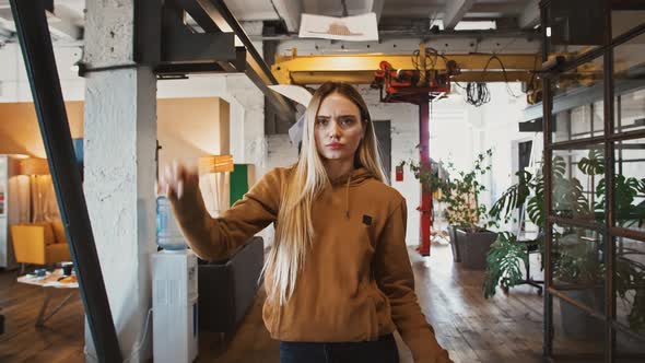 Young Woman Throwing Work Papers Walking Through Office