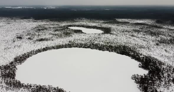 Flying Over Two Frozen Lakes in a Bogland