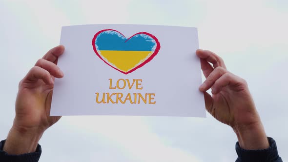 Man Hands Holding of Heart Drawingon the Cardboard with Words Love Ukraine