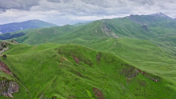 Flying Above Rocks And Green Hills At Georgian Highlands In Summer