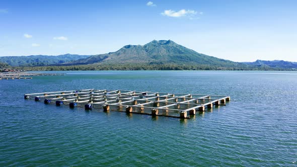 A Beautiful Flyby Above the Fish Farm on Shore of Lake Batur with Green Water