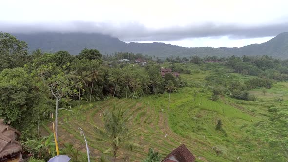 Aerial view of small straw bungalow neighborhood, Bali island, Indonesia.