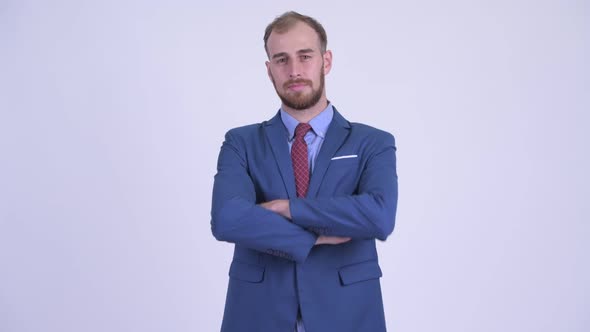 Happy Bearded Businessman Smiling with Arms Crossed