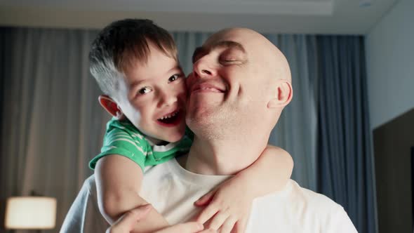 Portrait of an Affectionate Happy Cute Child Charming Kid a Son Hugging and Kissing His Father