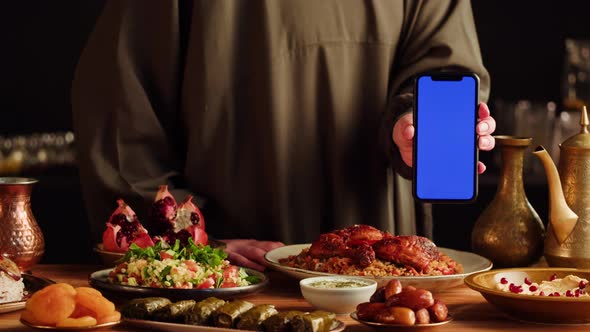 Kabsa Hummus Dolma Maqluba Tabbouleh Closeup Smartphone with Blue Chroma Key Screen Middle Eastern