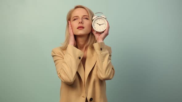 Style woman with alarm clock and headache on blue background