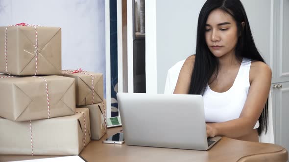 Young Pregnant Checking The Package On Table