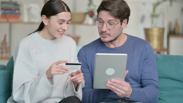 Hispanic Couple Making Successful Online Shopping on Tablet