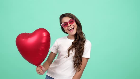Portrait of Happy Child in Glasses Showing Tongue Hold Heart Party Balloon Party Fun