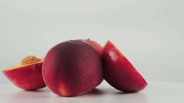 Close Up of Nectarine and Peaches on Rotating Table Isolated on White Background