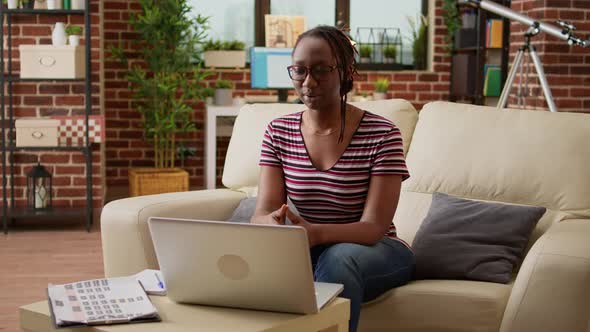 Female Freelancer Attending Business Videocall Meeting on Laptop