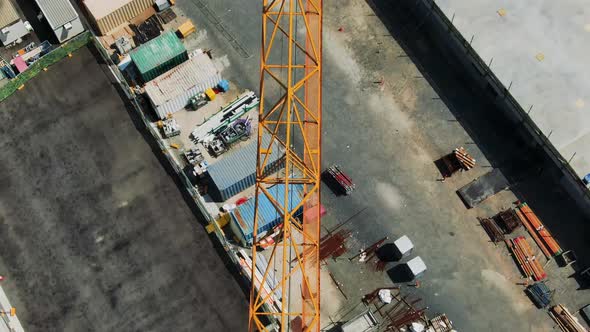 Slow pull up revealing full length of crane sunny day, building site