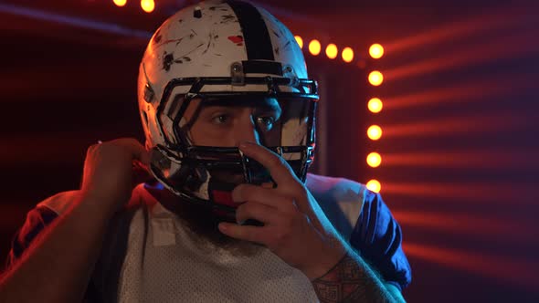 American Football Championship Game Close Up Portrait of Professional Player Putting on Helmet