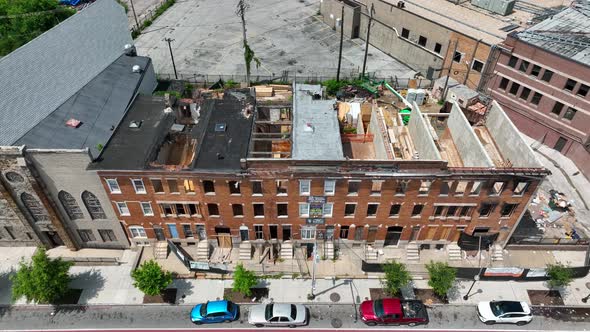 Abandoned boarded up homes in crime neighborhood in USA. Missing roof and windows. Aerial view in US