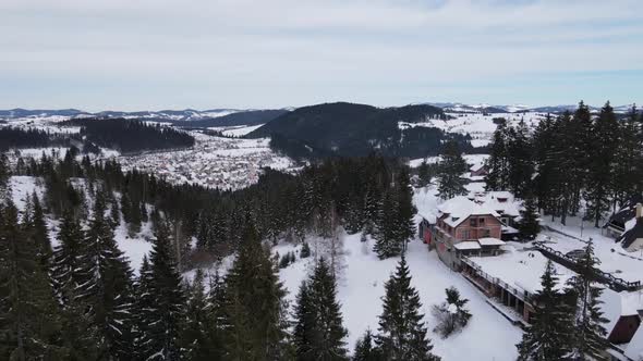 Ski center town, aerial shot with hotels, houses, trees, panoramic view, everything covered with sno