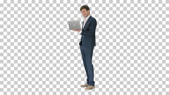 Businessman using laptop computer standing, Alpha Channel