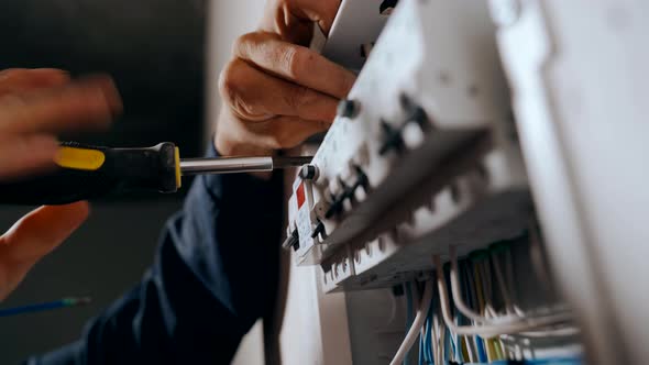 An Electrician Assembles an Electrical Panel in an Apartment