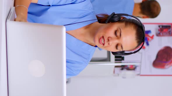 Vertical Video Medical Assistant Operator with Headphone Consulting Patients