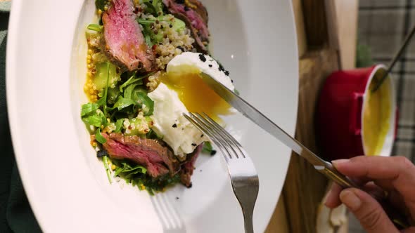 Woman Eating Salad with Poached Egg