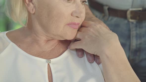 Close-up of Unrecognizable Old Woman Taking Hand of Senior Man. Couple of Caucasian Retirees in