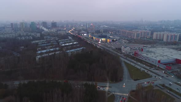 Autumn Forest and Road Junction Near Large City in Evening