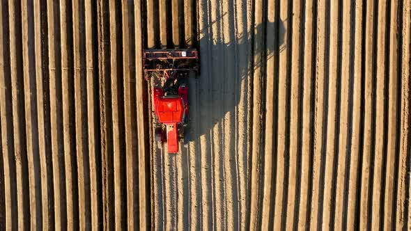 Aerial View of Tractor Performs Seeding on the Field